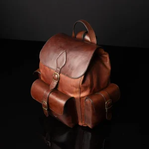 Side view of Explorer Large Backpack in vintage brown leather, showcasing structured side pockets with buckle closures.