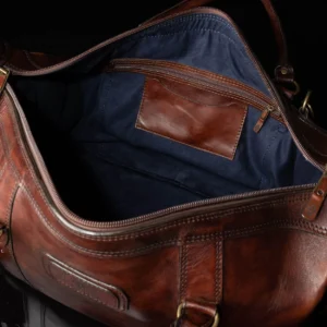 Interior of Mansfield Duffle Bag in vintage brown leather, showcasing its spacious main compartment and luxurious lining.