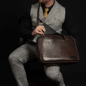 Side view of Astin Sleek brown leather laptop bag, featuring durable leather handles and a streamlined silhouette.