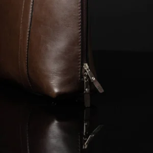 Close-up of Reagan Euro brown leather laptop bag zipper, designed for full-length opening to the base.