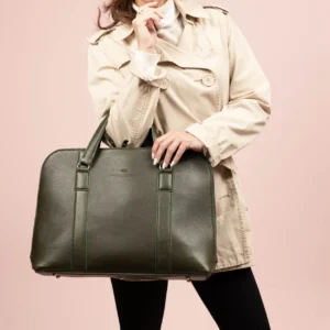 Model showcasing the women's Reagan Euro olive green leather laptop bag, styled for a chic, contemporary look.