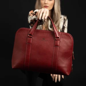 Close-up of the women's Reagan Euro ruby red leather laptop bag, showcasing its premium craftsmanship and polished finish.