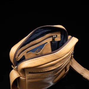 Tan Montrose Sling Bag, showing its durable leather material, spacious interior, and versatile strap for crossbody wear.