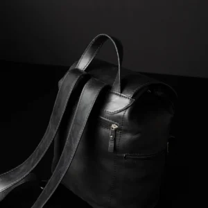 Side top view of Women’s Explorer Medium Backpack in black leather, showcasing back zipper pocket and adjustable leather straps.