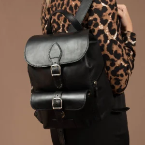 Women’s Explorer Medium Backpack in black leather, worn by model, showcasing a lightweight and stylish fit for everyday use.