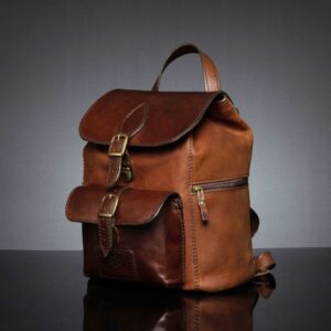 angled view of Women’s Explorer Medium Backpack in vintage brown leather, showcasing its side zip compartment and classic silouette.