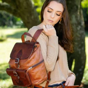 Women’s Explorer Medium Backpack in vintage brown leather, worn by model, highlighting its elegant and comfortable fit.