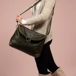 Model wearing Women's Monroe 2-in-1 bag in olive green leather as a sling, showcasing its versatility and spacious compartments.