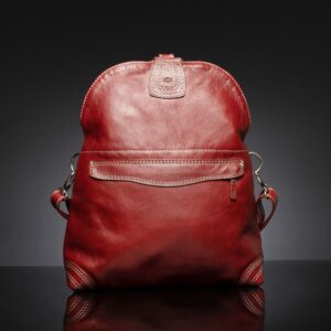 Women's Monroe 2-in-1 bag in ruby red leather, displayed in full backpack form, highlighting its structured design and premium craftsmanship.