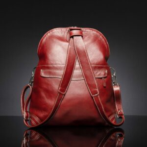 Rear view of Women's Monroe 2-in-1 backpack in ruby red leather, featuring adjustable straps and a zippered compartment.