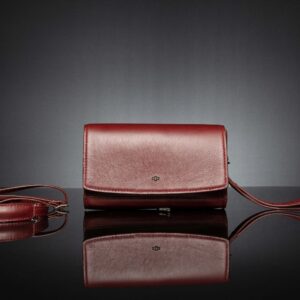 Women's Monroe clutch bag in ruby red full-grain leather, blending elegance and functionality with premium craftsmanship.