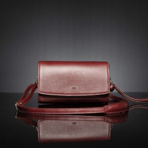 Monroe ruby red clutch bag with detachable straps, allowing easy conversion between a clutch and a sling bag.