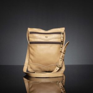 Women's Dakota Sling Bag in tan leather, a lightweight everyday bag with an adjustable strap.
