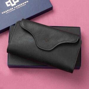 Women's black leather Genevieve smart phone purse and clutch, elegantly presented in a Charles Lansdown gift box, featuring a curved magnetic closure and dual zip compartments.