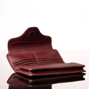 Inside compartments of a ruby red Genevieve leather purse, showcasing 12 card slots, dual zip compartments, and an expanding pouch for smartphone storage.