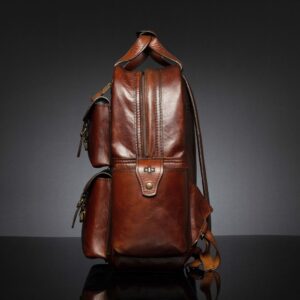 Side angle of Franklin men's leather laptop backpack, highlighting ergonomic straps and reinforced craftsmanship.