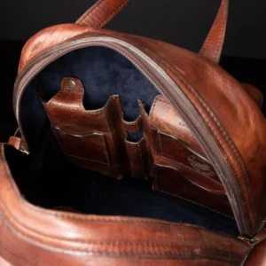 Interior view of the Franklin backpack, showcasing multiple leather compartments and organizational leather pockets.