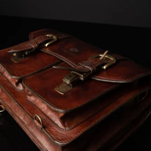 Flat view of Benjamin Classic Laptop Bag, featuring vintage-inspired buckled closures and durable leather construction.