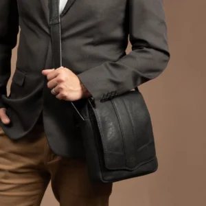 Model carrying the Indiana black leather sling bag, showcasing its sophisticated and practical design.