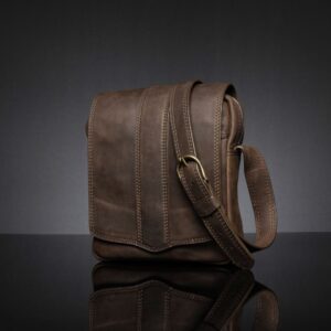 Brown Indiana men's sling bag crafted from genuine leather, featuring secure zippered compartments.