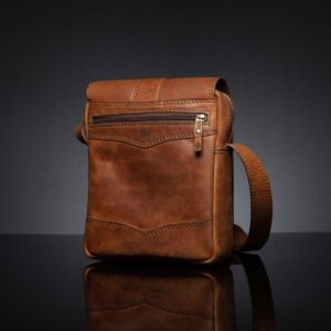 Rich brown Indiana leather sling bag with multiple compartments and a classic structured design.