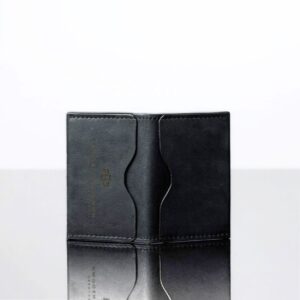 Men’s slim black leather cardholder with four curved slots. Durable bifold design for minimalist and secure card storage.