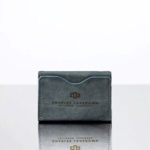 Men’s Dakota Bifold Cardholder in denim blue. Full-grain leather, minimalist design, curved slots, and embossed Charles Lansdown logo.