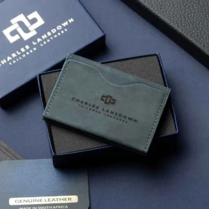 Men’s Dakota Bifold Cardholder in denim blue on a luxury gift box. Handcrafted full-grain leather with curved slots for sleek storage.