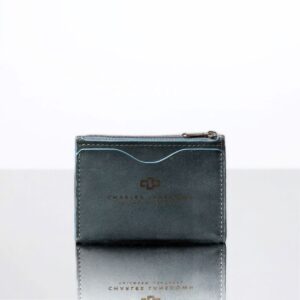 Men’s Dakota Zipped Cardholder in denim blue. Premium full-grain leather, minimalist design, curved slots, and secure zip closure.