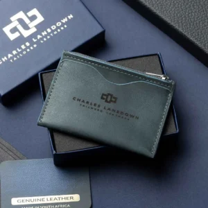 Men’s Dakota Zipped Cardholder in denim blue on a luxury gift box. Handcrafted full-grain leather with curved slots and a secure zip.