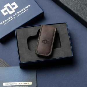 Men's brown leather Belvoir money clip, elegantly placed in a Charles Lansdown gift box, designed for secure and stylish note carrying.