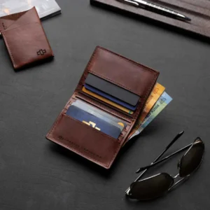 Men’s Mansfield Bifold Wallet in rich brown, placed on a desk. Classic leather wallet designed for modern style and function.