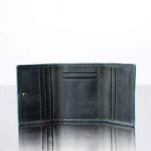 Open Ashford denim blue trifold wallet displaying multiple card slots and a spacious note section for organized storage.