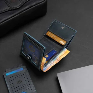 Men's Ashford Trifold Wallet in denim blue leather, open to reveal its functional layout, including multiple card slots and ID window.