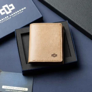 Men’s Ashford Trifold Wallet in tan leather, placed inside an open Charles Lansdown gift box, showcasing premium craftsmanship.