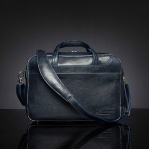 Front view of Astin Sleek navy blue leather laptop bag, highlighting its detachable leather shoulder strap for flexible carrying options.