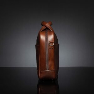 Side view of Astin Sleek polished brown leather laptop bag, featuring a full-length zipper for wide and easy access to the interior.