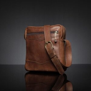 Side view of the rich brown Montrose Sling Bag, highlighting fine stitching and durable brass hardware.