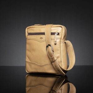 Side view of the Montrose Sling Bag in tan leather, highlighting the adjustable strap and reinforced stitching.