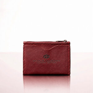 Women's Dakota zipped curved leather cardholder in ruby red, studio view.