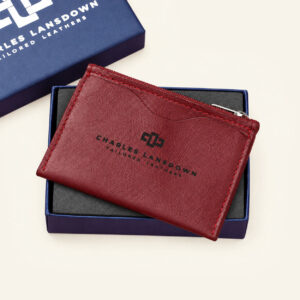 Women's Dakota zipped curved leather cardholder in ruby red, presented in its Charles Lansdown gift box.