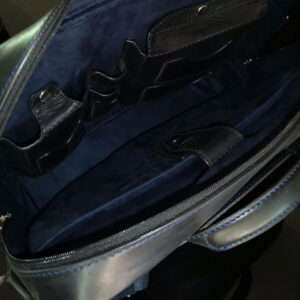 Interior of Astin Sleek black leather laptop bag, featuring a padded laptop section and multiple pockets for organized storage.