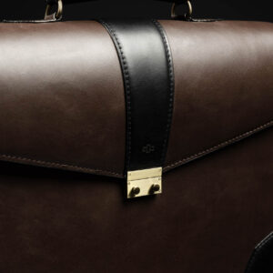 Side view of Svelte Laptop Bag, featuring a polished metal buckle and structured design.