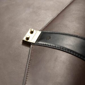 Close-up of Svelte Laptop Bag’s polished metal buckle, crafted for secure closure and a sleek aesthetic.