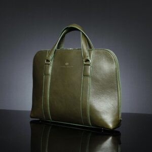 Angled side view of women's Reagan Euro olive green leather laptop bag, highlighting reinforced leather handles and smooth finish.