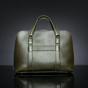 Back view of women's Reagan Euro olive green leather laptop bag, featuring a luggage strap for secure travel attachment.