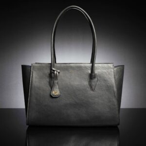 A women's black leather Aria Tote Laptop Bag with a structured design, flared sides, and space for a 13"-15" laptop.