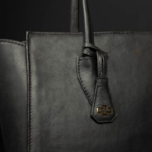 A close-up of the Aria Tote's high-quality leather and reinforced stitching, ensuring durability and refined craftsmanship.