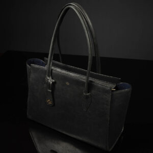 The Aria Tote Laptop Bag from a side angle, showcasing its premium craftsmanship, durable zippers, and strong handles.