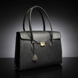 Side profile of the women's black leather tote bag, highlighting its structured form and sturdy top handle.
